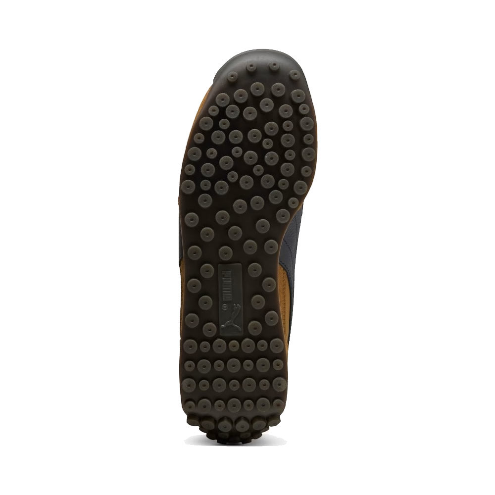 Displays the full-length studded rubber outsole, showcasing the iconic conical traction studs, perimeter gripping blocks, and central recessed PUMA logo bridge.