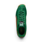 Overhead look at the shoe highlighting the Archive Green textile vamp, reinforced suede T-toe mudguard, central lacing system with flat tonal green laces, vintage woven PUMA tongue label, and dark green cushioned footbed.