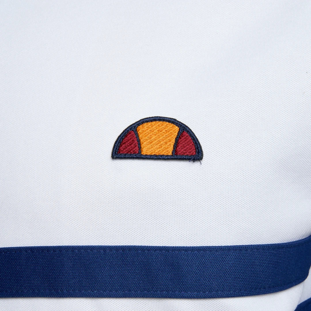 Close-up zoom on the fabric of the Ellesse Rimini Track Jacket in white, showing the smooth tricot texture and the embroidered Ellesse logo on the chest.