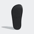 Focusing on the EVA outsole grip pattern, showcasing the traction designed for a successful tackle of wet poolside surfaces.