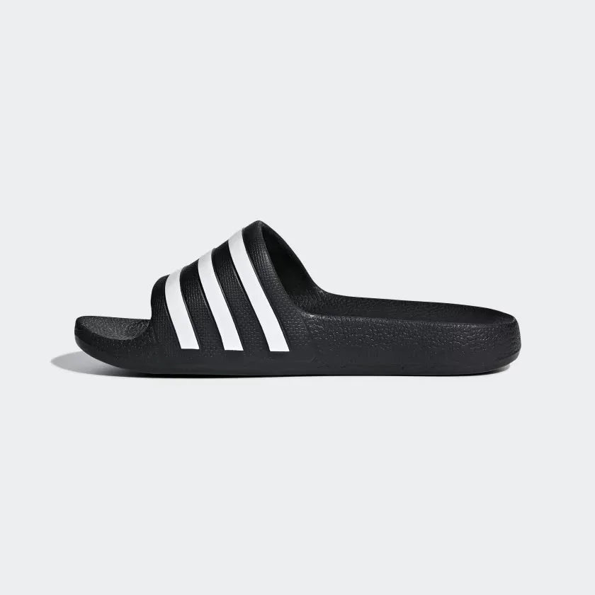 Black slide sandal with white stripes on a white background