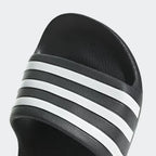 Focusing on the Moulded 3-Stripes, showcasing the high-definition branding and seamless hardware as the stylish final detail.