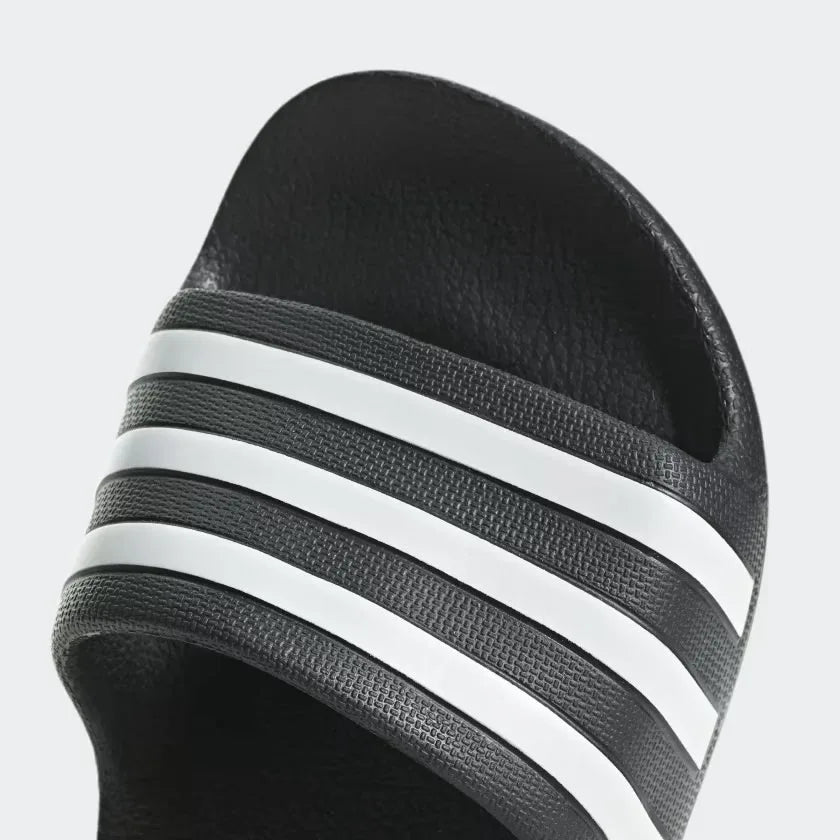Focusing on the Moulded 3-Stripes, showcasing the high-definition branding and seamless hardware as the stylish final detail.