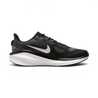 A Nike running shoe in black and white, featuring a textured black mesh upper, a white Nike Swoosh, and a thick white and black midsole, shown from a side profile on a light gray background.