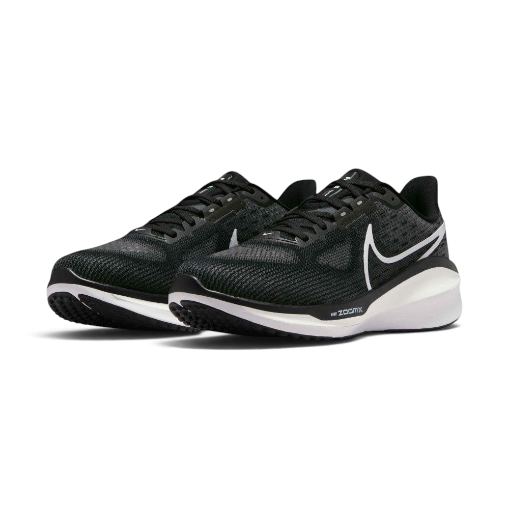 Emphasising the maximalist, forward-leaning athletic stance of the trainers and the professional harmony of the deep black uppers sitting cleanly above the white and dark charcoal sole tooling components.