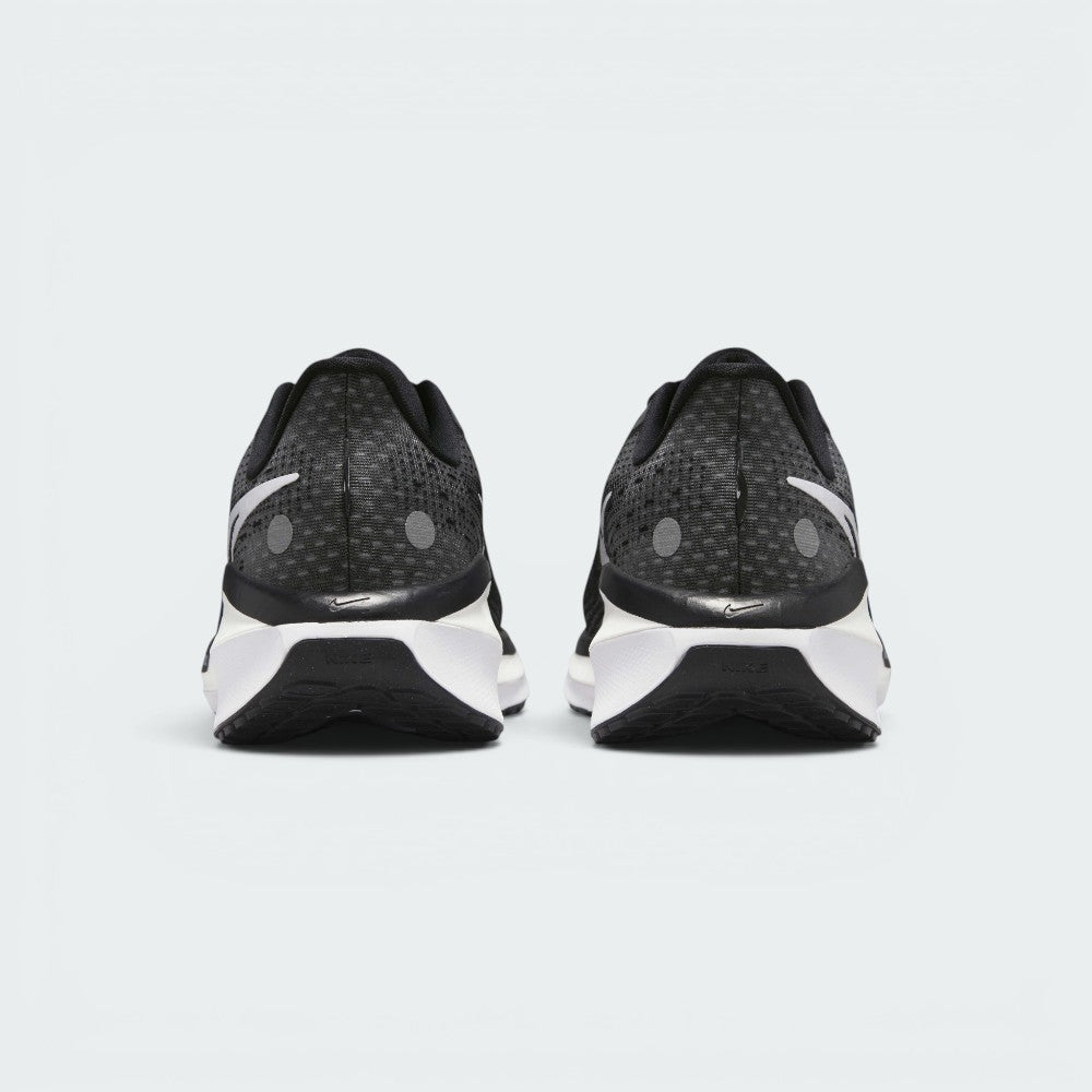 Focuses on the contoured shape of the padded ankle collar, highlighting the thick plush heel lining and the robust, wide footprint of the sole unit engineered for maximum landing stability.