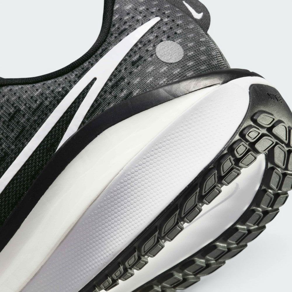 Highlights the "unreal" clean finish where the responsive foam carrier meets the high-traction road rubber base, framing the technical compression lines of the ZoomX cushioning layer above.