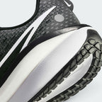 Highlights the "unreal" clean finish where the responsive foam carrier meets the high-traction road rubber base, framing the technical compression lines of the ZoomX cushioning layer above.