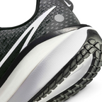 Highlights the "unreal" clean finish where the responsive foam carrier meets the high-traction road rubber base, framing the technical compression lines of the ZoomX cushioning layer above.