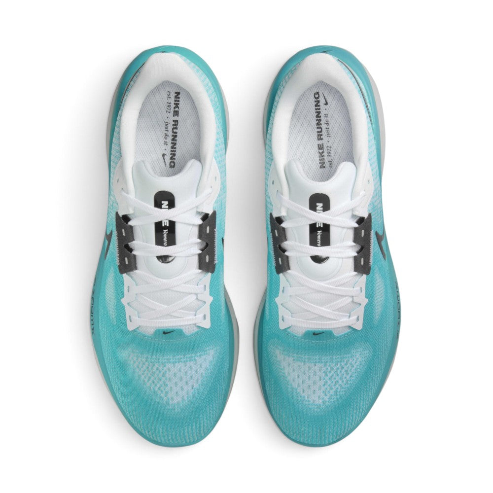 Focuses on the locked-in central lacing layout, displaying the clean white laces, dark grey midfoot eyestay reinforcement tabs, white padded tongues with black "NIKE Vomero" branded badges, and white insoles printed with "NIKE RUNNING est. 1972 • just do it •".