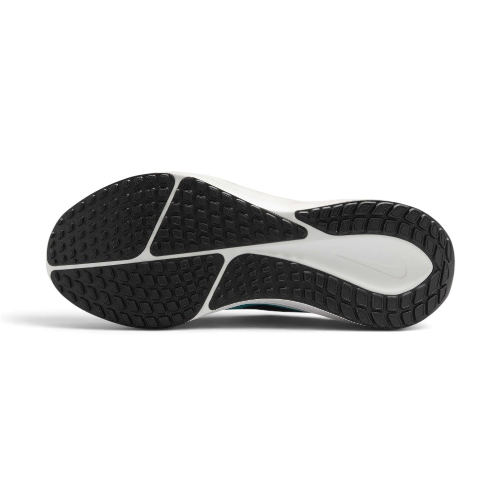 Displays the full-length black and white rubber Waffle sole, showcasing the multi-directional traction lug pods, deep central decoupling groove, and recessed white midsole cavity featuring a tonal Nike Swoosh.