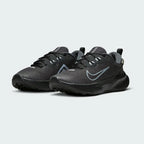 Angled view of two Nike Juniper Trail 2 Gore-Tex Women's black trainers, side by side, showcasing their robust design and athletic silhouette.
