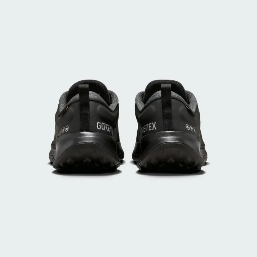 Rear view of the Nike Juniper Trail 2 Gore-Tex Women's black trainers, focusing on the structured heel and subtle branding.