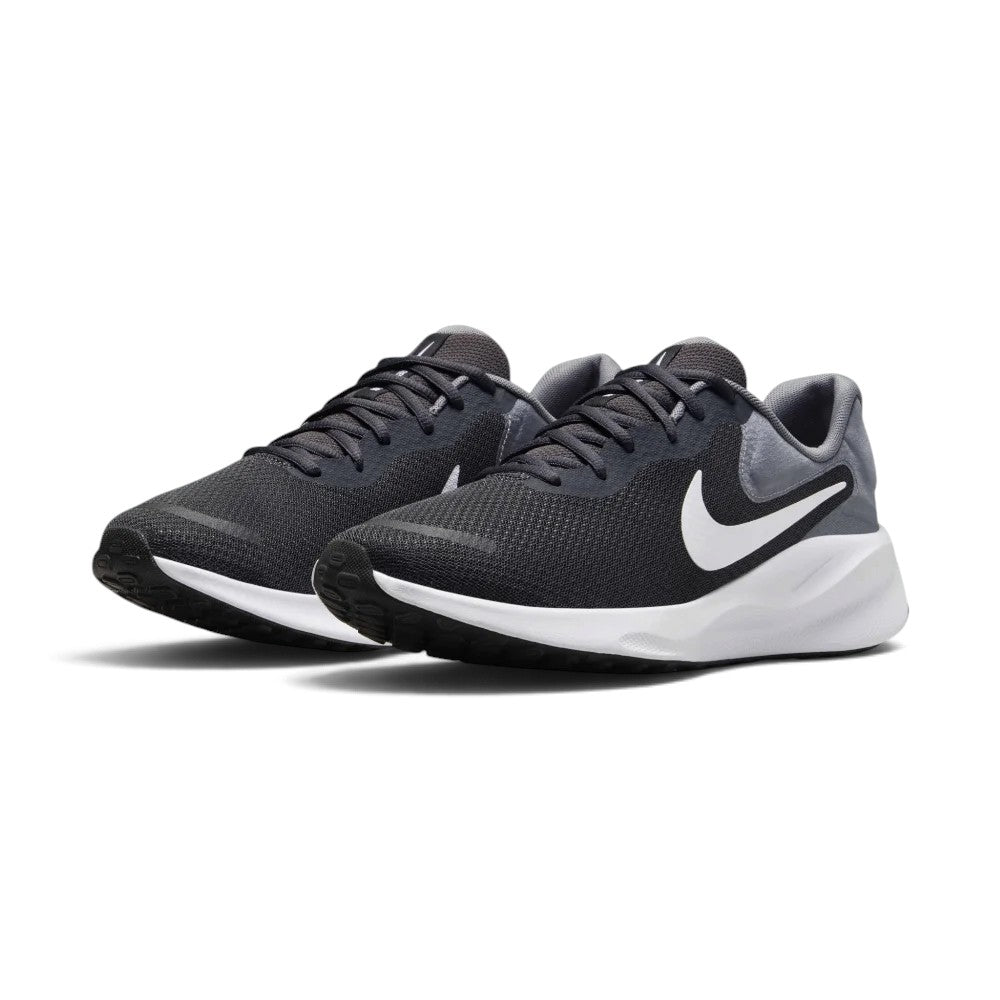Three-quarter forward angle of the Nike Revolution 7 trainers, showcasing their streamlined athletic silhouette and clean grey-and-white color blocking.