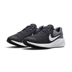 Three-quarter forward angle of the Nike Revolution 7 trainers, showcasing their streamlined athletic silhouette and clean grey-and-white color blocking.