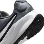 Macro view of the lateral heel transition, highlighting the soft foam midsole contour and durable rubber outsole tread pods.