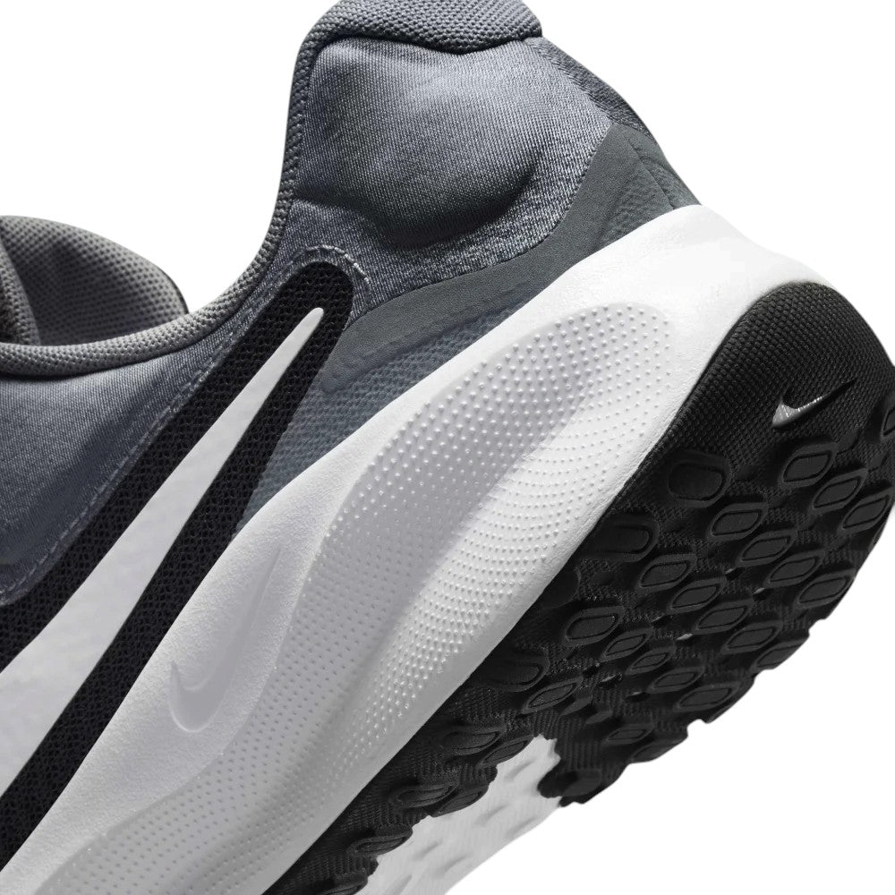 Macro view of the lateral heel transition, highlighting the soft foam midsole contour and durable rubber outsole tread pods.