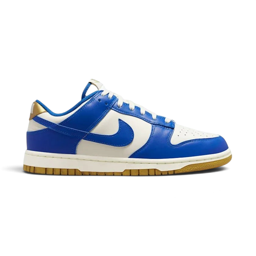Nike Dunk Low Women's White Leather Trainers FB7173-141 side view showing white leather upper with light blue Swoosh and classic cupsole