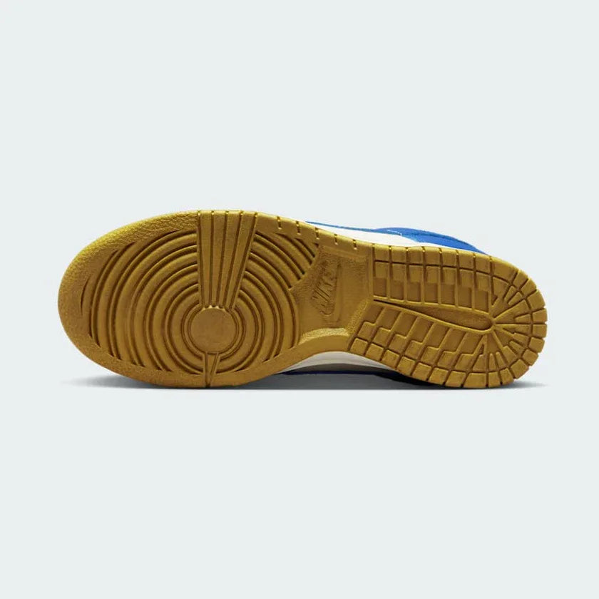 Nike Dunk Low Women's White Leather Trainers FB7173-141 outsole with pivot-circle traction pattern in light blue rubber