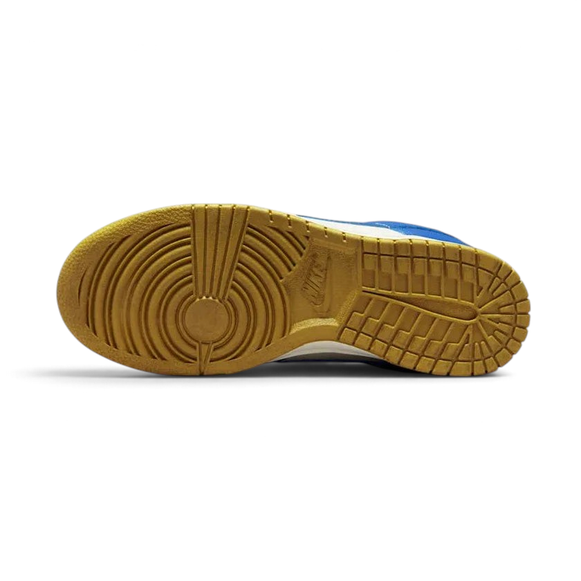 Nike Dunk Low Women's White Leather Trainers FB7173-141 outsole with pivot-circle traction pattern in light blue rubber