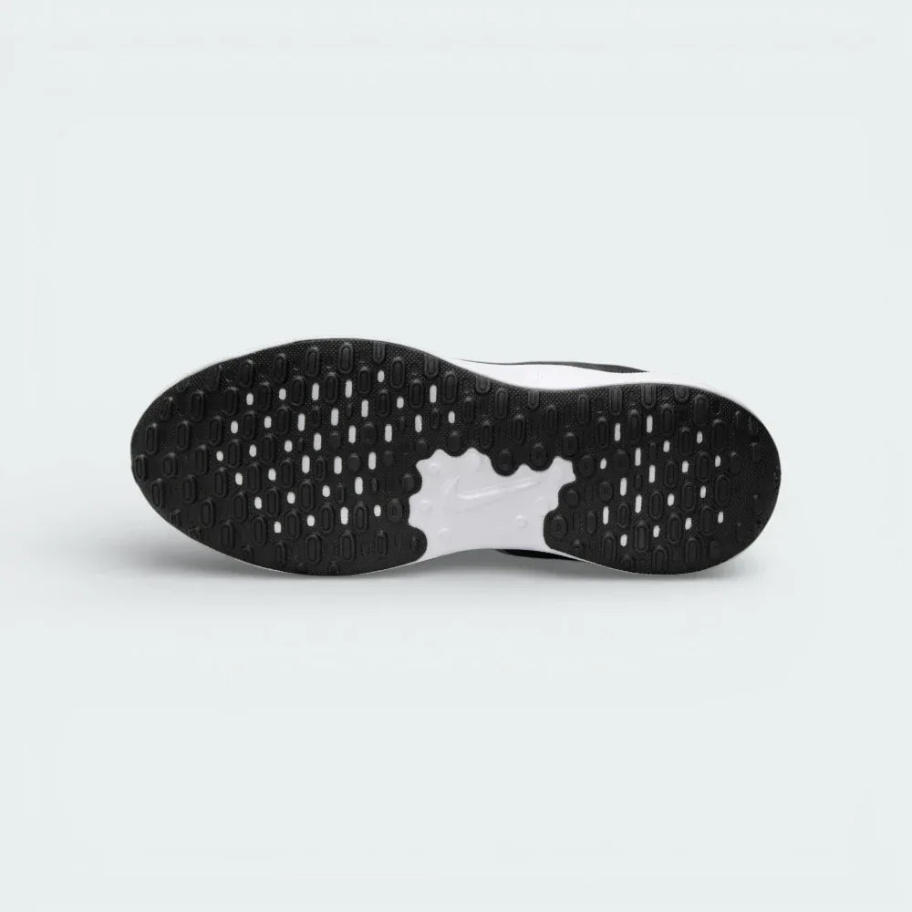 View of the black rubber outsole, showcasing the updated traction pattern and flexible grooves for a natural stride.