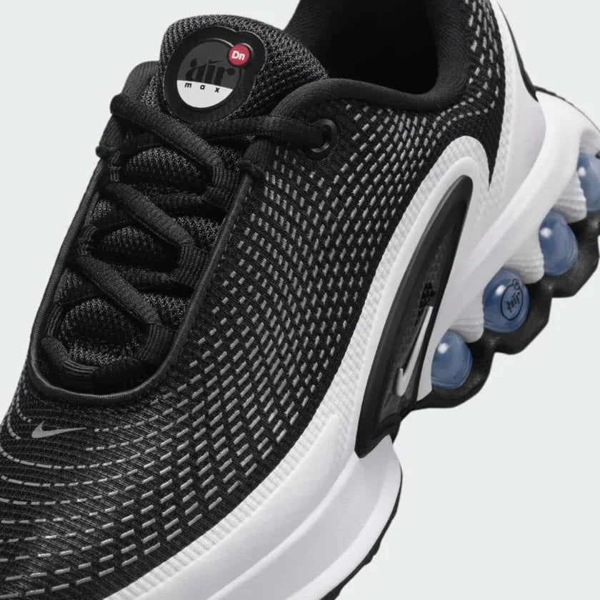 Close-up of Nike Air Max DN Juniors Casual Trainers FB8987-003 laces, mesh upper, and branding