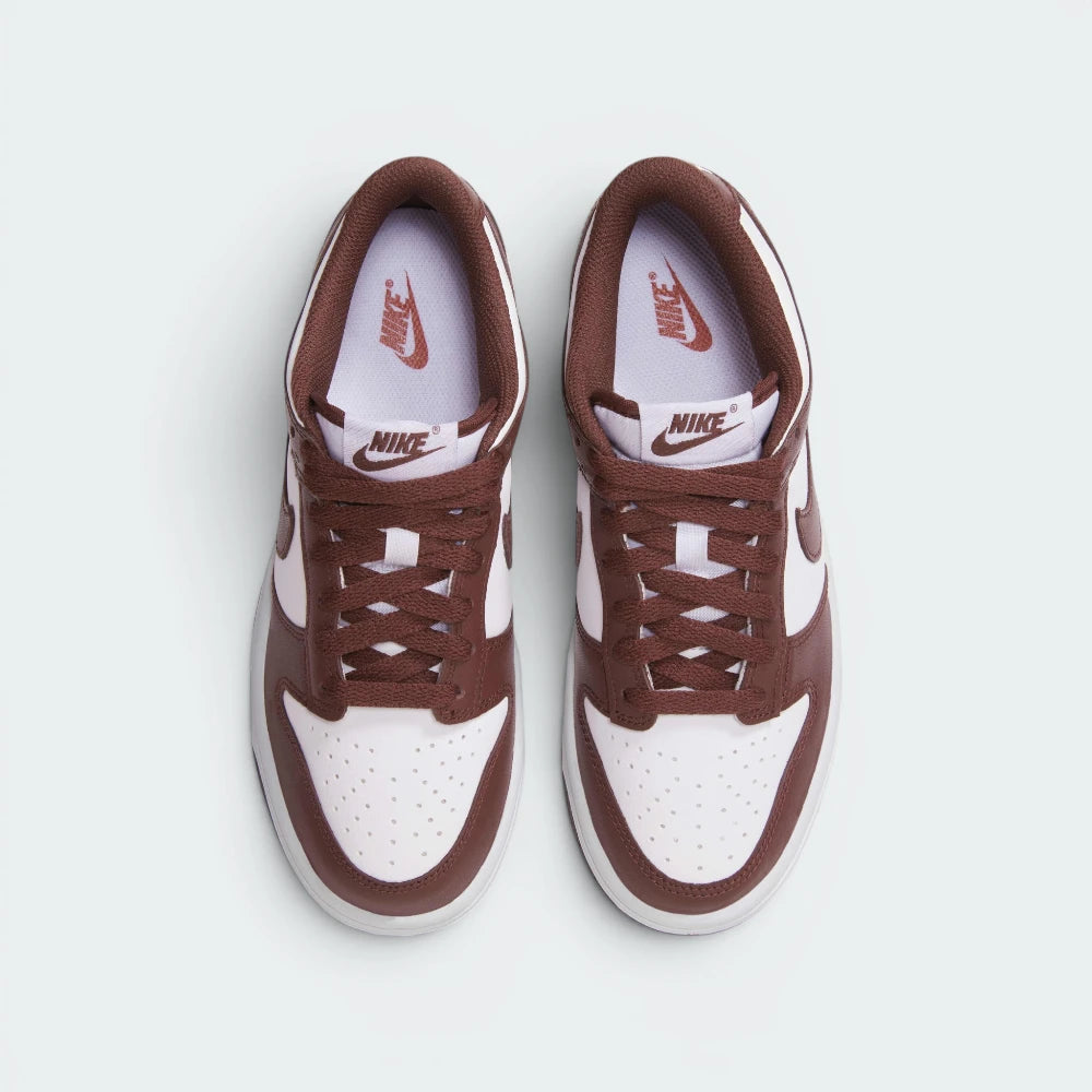 Focuses on the locked-in traditional lacing layout, displaying the perfect symmetry of the white textile tongue, the red branded tongue tab, and the iconic neat rows of perforations guarding the front toe box area.
