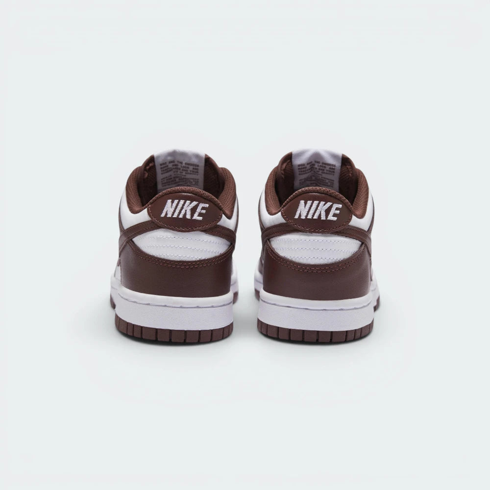 Focuses on the contoured shape of the padded low-cut collar, highlighting the clean embroidered Nike block text stitched squarely into the deep Redwood rear heel overlay panel.