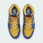 Top-down view of a pair of Air Jordan 1 Hi Retro OG Women's trainers in yellow and blue, highlighting their classic silhouette and lace-up closure.
