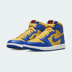 Angled view of two Air Jordan 1 Hi Retro OG Women's yellow and blue trainers, side by side, showcasing their iconic design and bold color blocking.