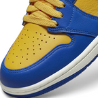Close-up zoom on the front of the Air Jordan 1 Hi Retro OG Women's yellow and blue trainers, showing the perforated toe box, lacing system, and textured leather upper.