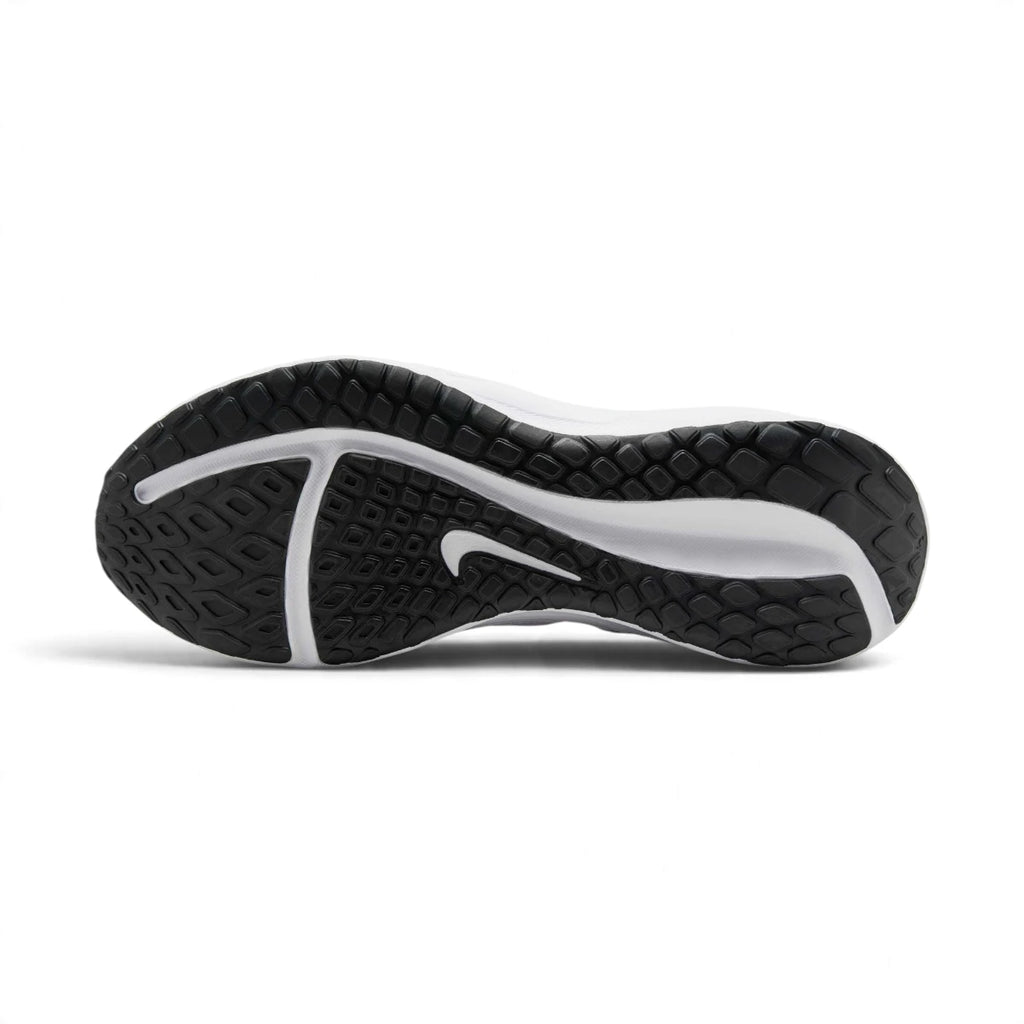 Full-length bottom profile showing the solid rubber outsole, highlighting the multi-directional road traction pattern, longitudinal flex siping grooves, perimeter grip pods, and debossed central Nike Swoosh.