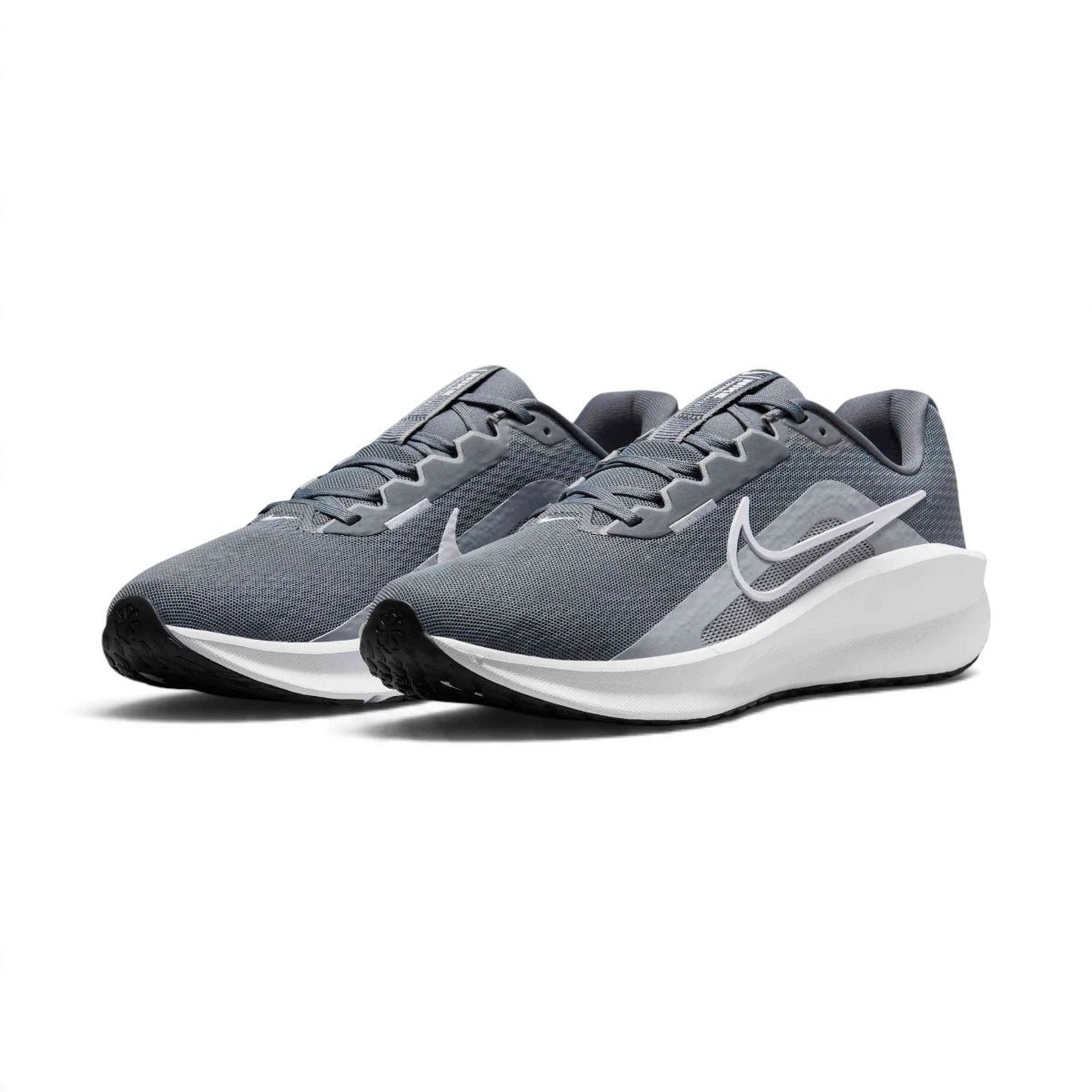Forward three-quarter angle showcasing both shoes side by side, highlighting the modern rocker running stance, streamlined toe spring, clean white Swoosh contrast, and balanced foam midsole stack height.