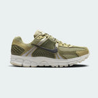 Highlights the high-velocity sweep of the black Nike Swoosh resting against the structural olive plastic side caging, showing the professional visual depth of the layered synthetic leather panels.