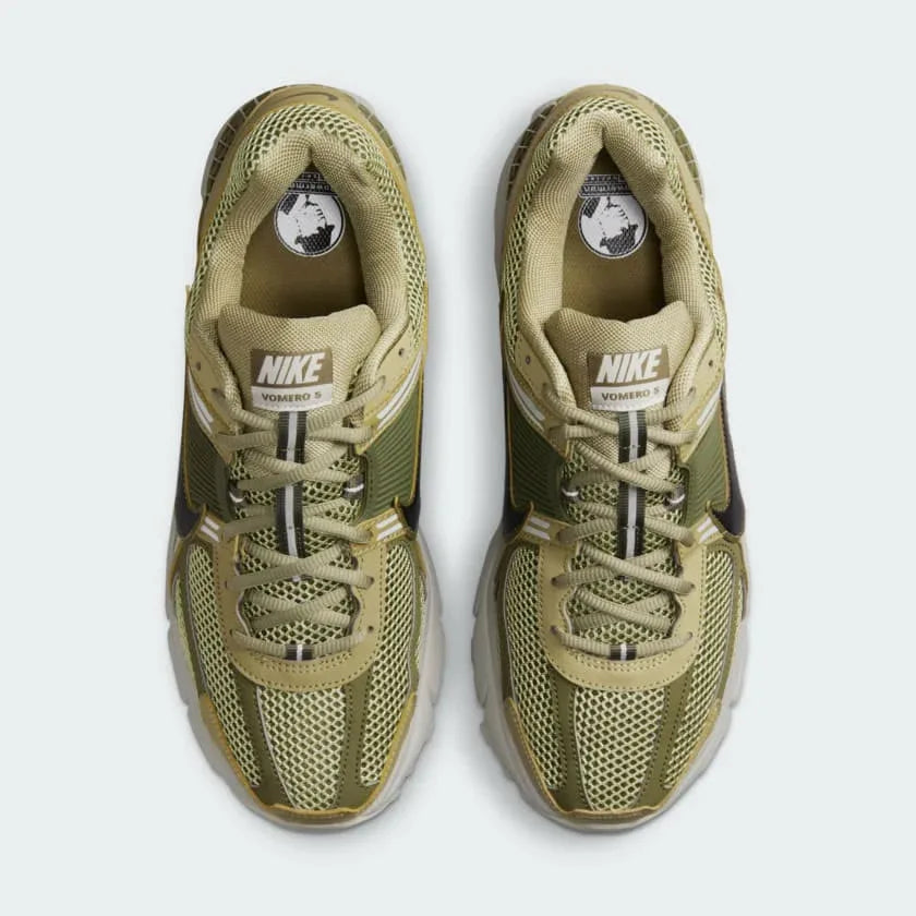 Focuses on the locked-in lace closure layout, showing the clean symmetry of the open mesh tongue and the tonal olive panels guarding the front toe box.