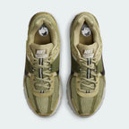 Focuses on the locked-in lace closure layout, showing the clean symmetry of the open mesh tongue and the tonal olive panels guarding the front toe box.