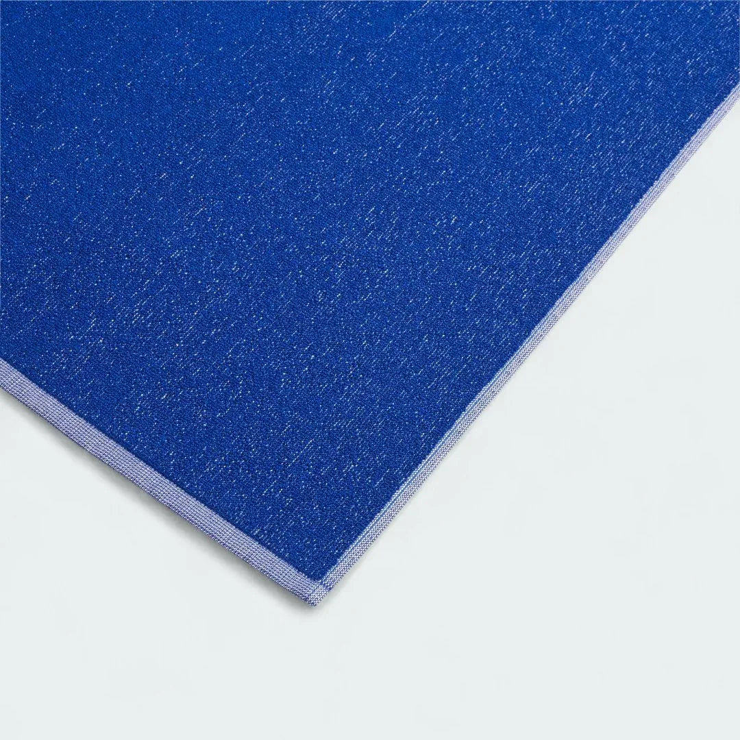 Close-up detail of the Adidas Cotton Towel in royal blue, showing the plush texture of the absorbent 100% cotton material.