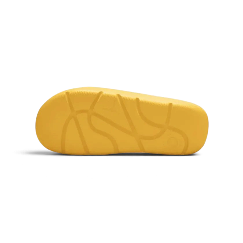 Trade Sports Air Jordan Post Slide in yellow ochre showing the textured multi-surface outsole with grip channels.