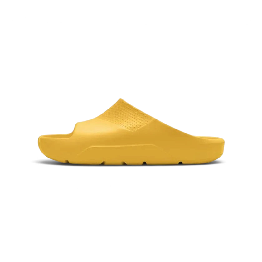 Trade Sports Air Jordan Post Slide in yellow ochre featuring a one-piece molded foam construction and side profile.