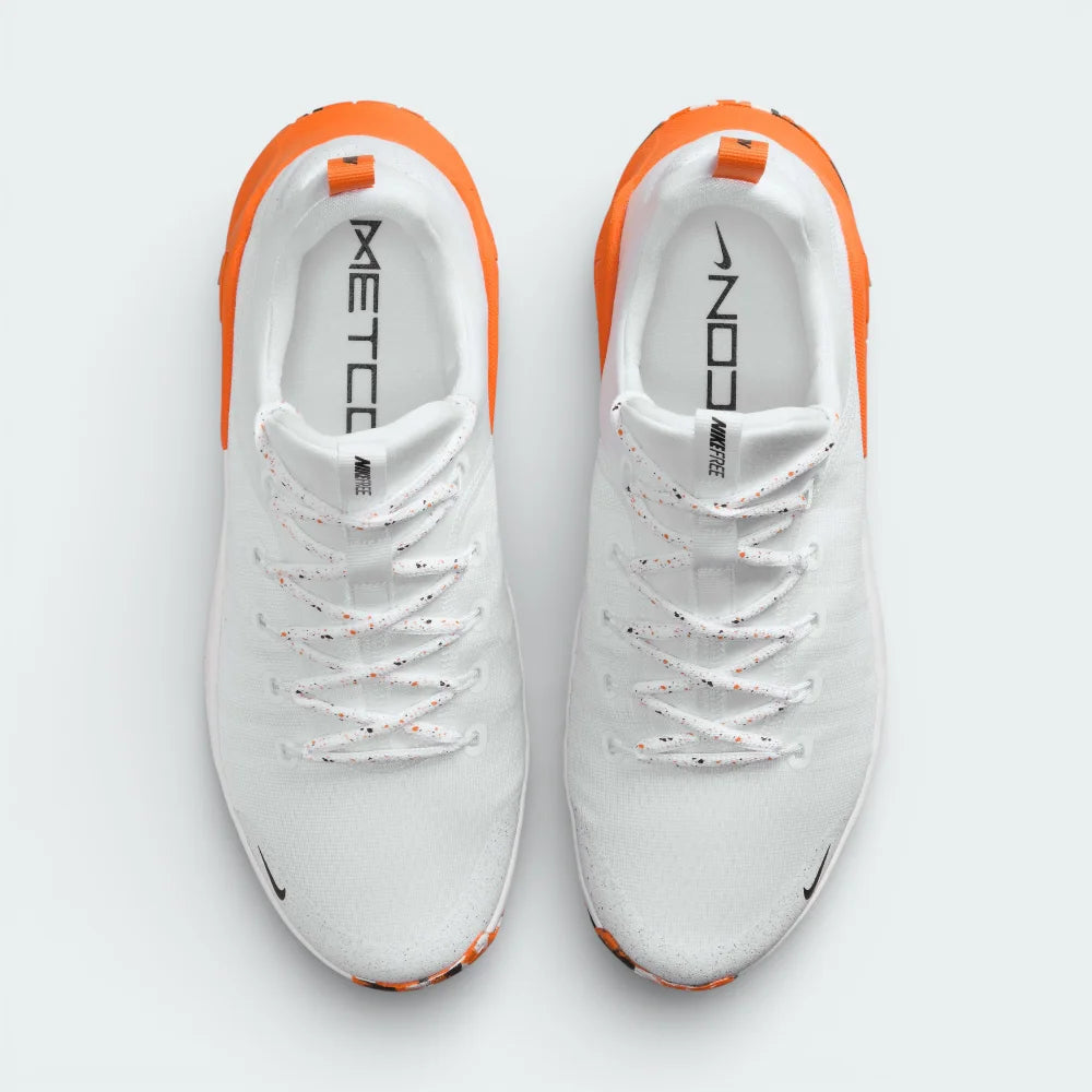 Top-down view of the White and Safety Orange trainers, highlighting the breathable haptic mesh and the integrated lacing system for a locked-in fit.
