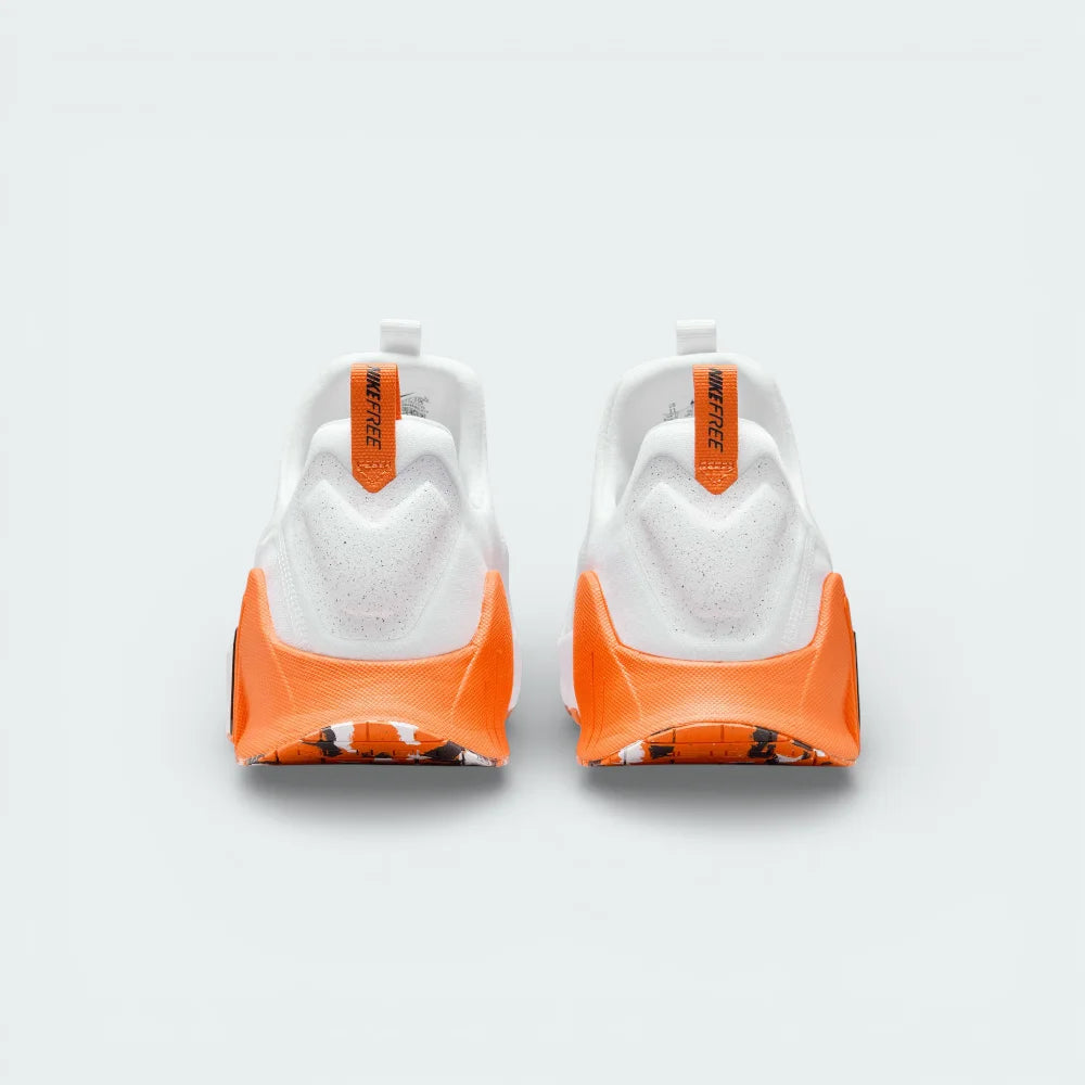 Rear view focusing on the wide Metcon heel structure and the Safety Orange pull tab for easy entry.