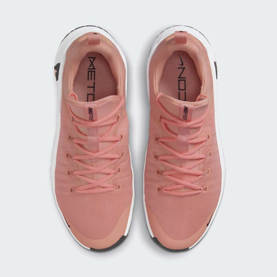 Top-down view of a pair of Nike Free Metcon 5 Men's training shoes in orange, highlighting their athletic silhouette and lace-up closure.