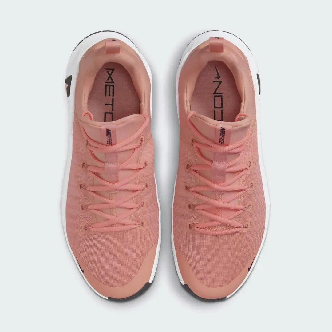 Top-down view of a pair of Nike Free Metcon 5 Men's training shoes in orange, highlighting their athletic silhouette and lace-up closure.
