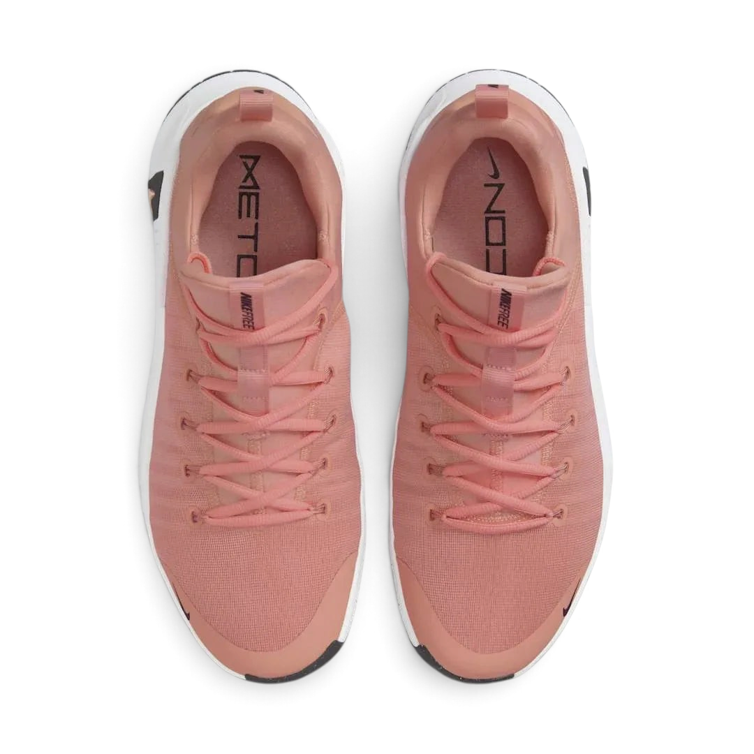 Top-down view of a pair of Nike Free Metcon 5 Men's training shoes in orange, highlighting their athletic silhouette and lace-up closure.