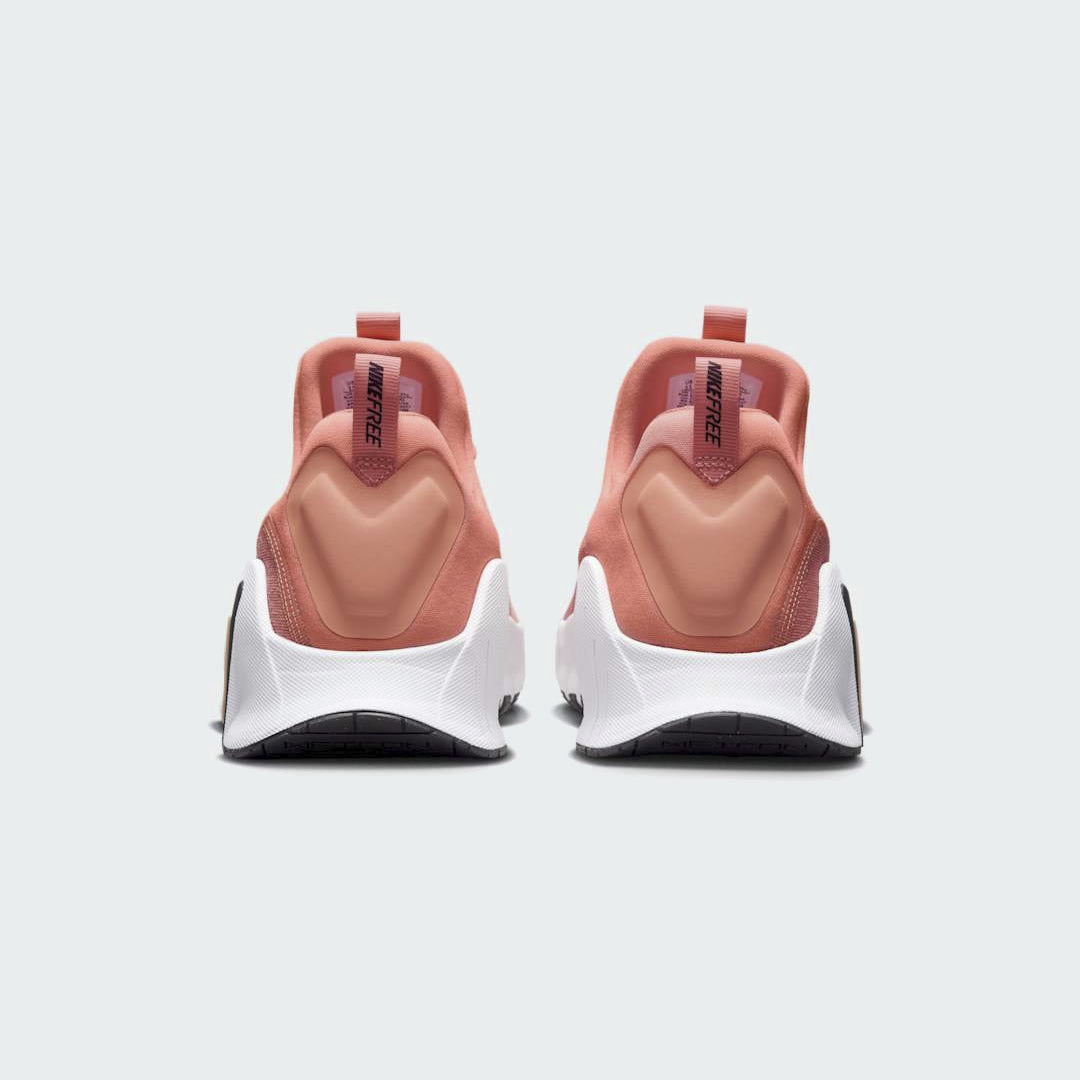 Rear view of the Nike Free Metcon 5 Men's orange training shoes, focusing on the wide, flat heel for lifting stability and subtle branding.