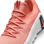 Close-up zoom on the front of the Nike Free Metcon 5 Men's orange training shoes, showing the breathable mesh upper texture, lacing system, and flexible toe area.