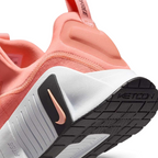 Detailed zoom on the outsole and midsole of the Nike Free Metcon 5 Men's orange training shoes, highlighting the dual-density cushioning and durable rubber for versatile training.