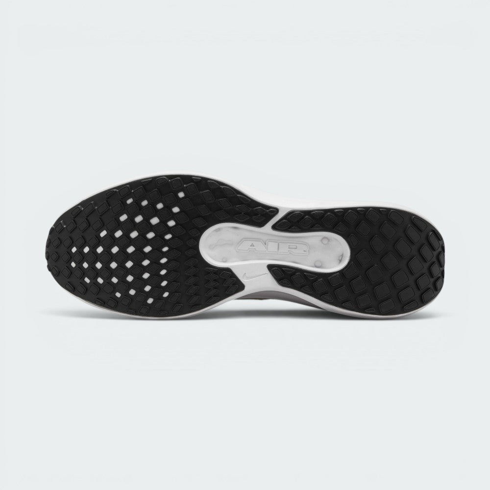 Bottom-up view of the Nike Air Winflo 11 outsole, displaying the black rubber grid traction pattern and a central white groove revealing the embossed "AIR" logo.