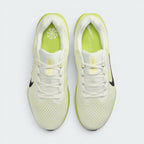 Top-down view of the pair of Nike Air Winflo 11 shoes side by side, showing the off-white laces, sail engineered mesh, and bright lime green insoles printed with white Nike branding.