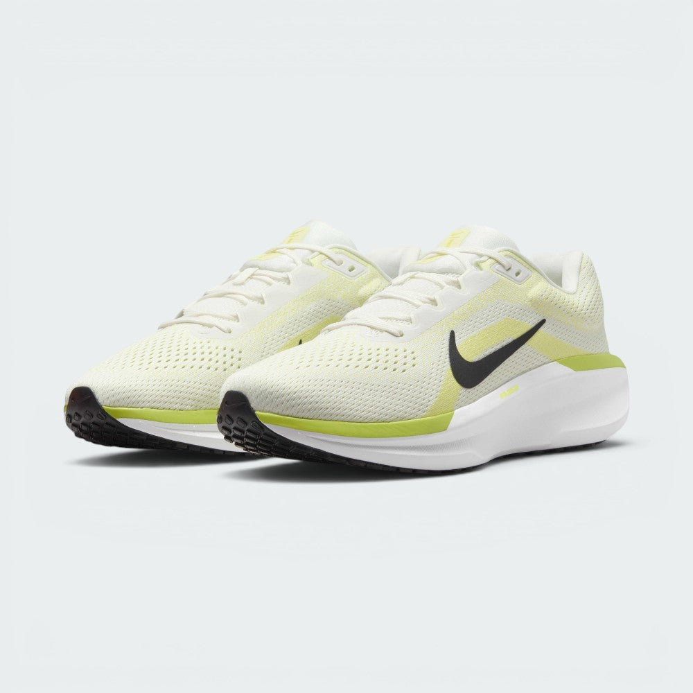 Three-quarter front angle view showing both Nike Air Winflo 11 shoes side by side, showcasing their athletic running stance, off-white mesh uppers, and bright lime green highlights.
